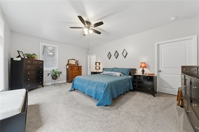 bedroom featuring ceiling fan and light colored carpet