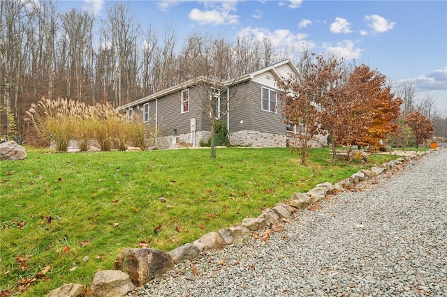 view of side of home featuring a lawn