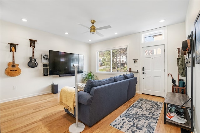 living room featuring ceiling fan and wood-type flooring