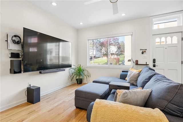 living room featuring ceiling fan, a healthy amount of sunlight, and light wood-type flooring