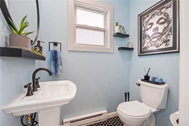 bathroom featuring baseboard heating and toilet