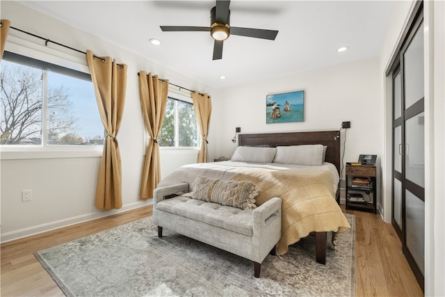 bedroom featuring ceiling fan and light hardwood / wood-style floors