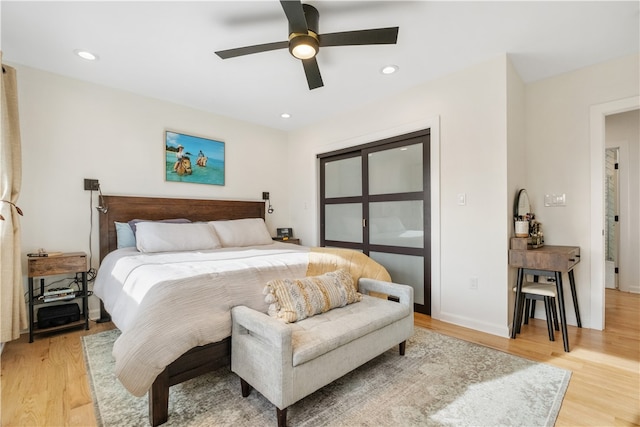 bedroom with ceiling fan and light wood-type flooring