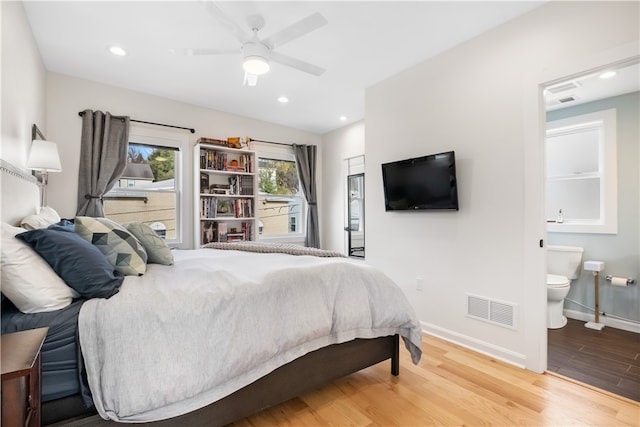 bedroom featuring ceiling fan, ensuite bathroom, and wood-type flooring