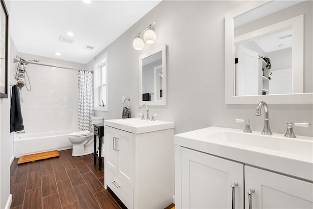 full bathroom featuring shower / bath combination with curtain, toilet, and vanity