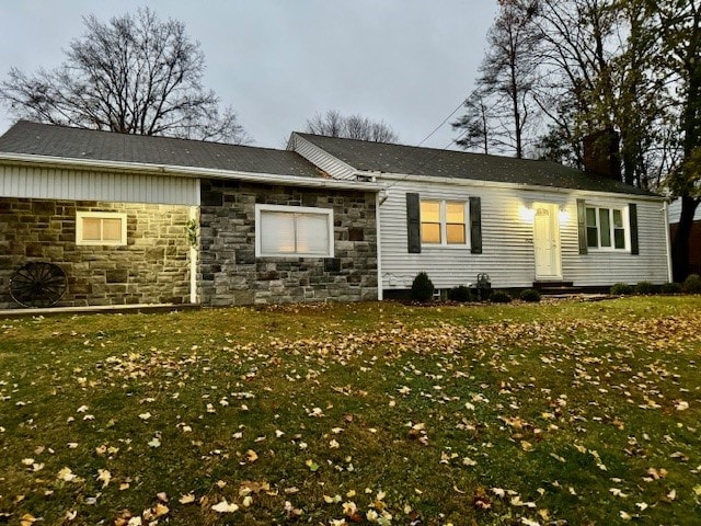 back of house with a lawn