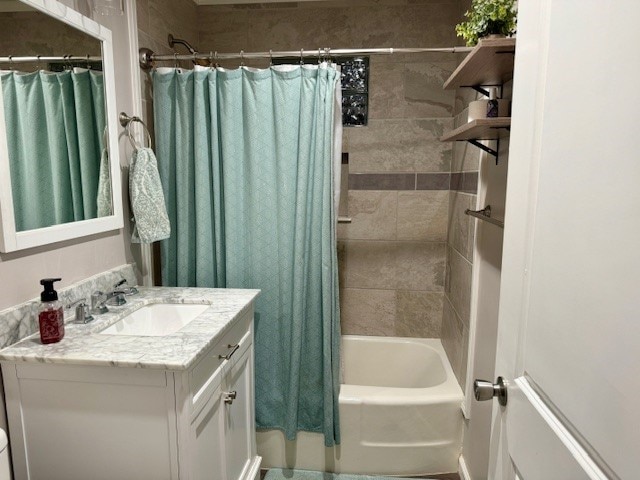 bathroom with shower / bath combo with shower curtain and vanity