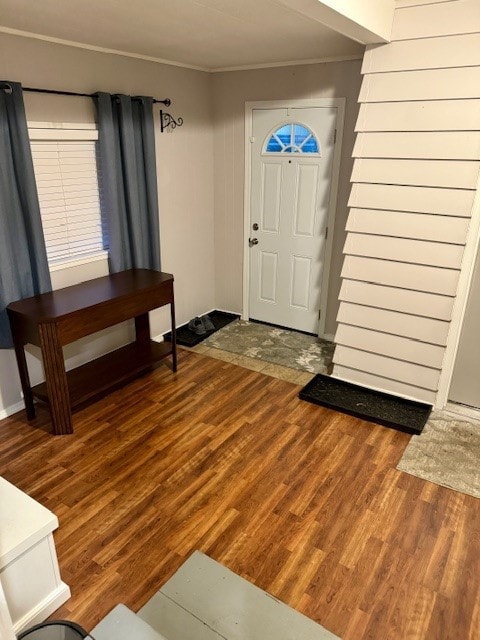 foyer with ornamental molding and hardwood / wood-style flooring