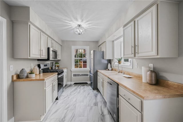 kitchen featuring white cabinets, appliances with stainless steel finishes, and sink