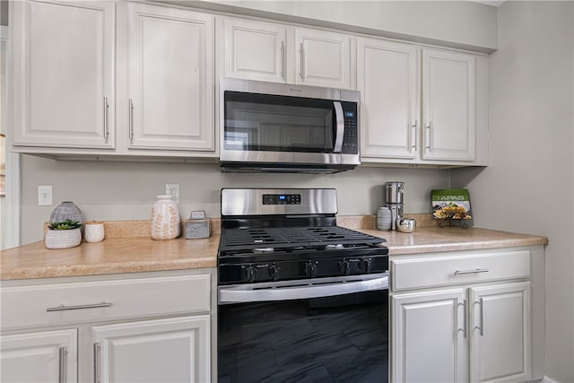 kitchen with white cabinetry and stainless steel appliances