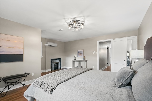 bedroom featuring hardwood / wood-style flooring and a wall mounted AC