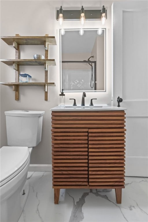 bathroom featuring toilet, a shower, and vanity