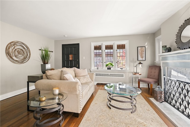 living room featuring dark hardwood / wood-style floors and radiator heating unit