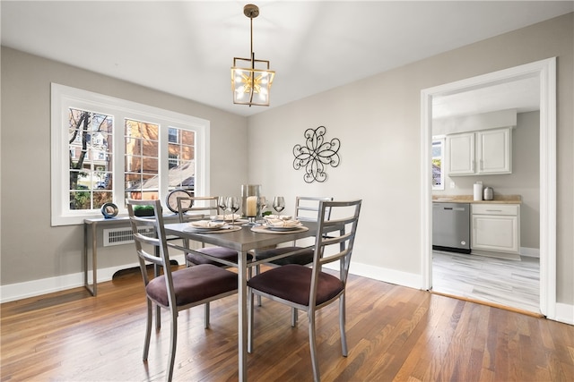 dining area featuring an inviting chandelier and hardwood / wood-style flooring