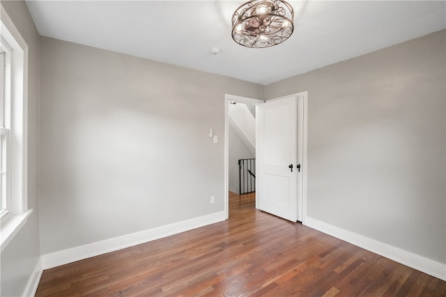 spare room with dark wood-type flooring