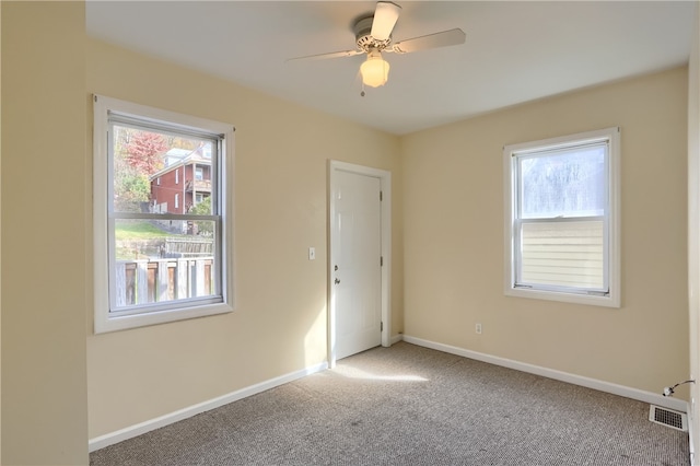 carpeted empty room with ceiling fan