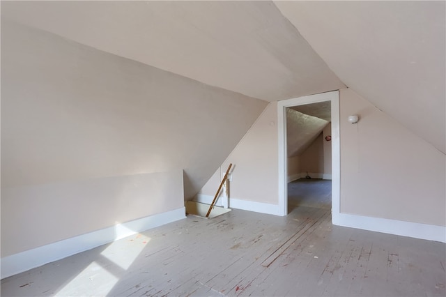 bonus room with light hardwood / wood-style floors and lofted ceiling