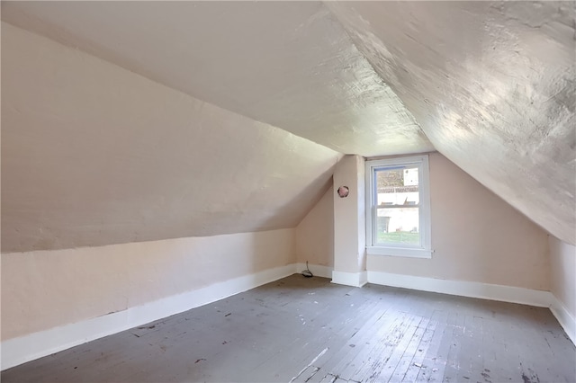 bonus room with dark hardwood / wood-style floors and lofted ceiling