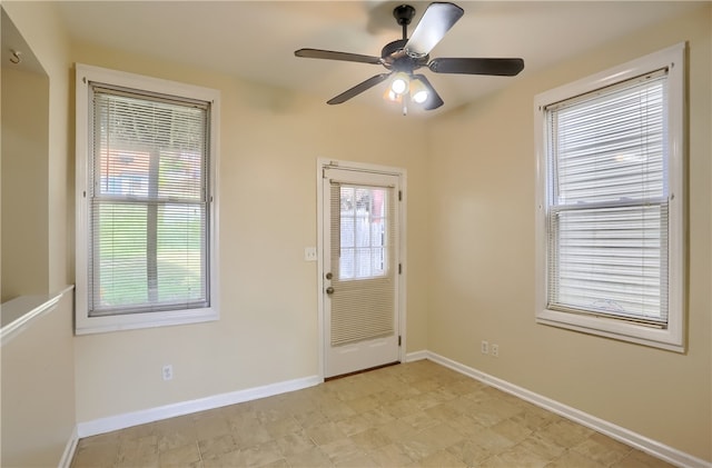 doorway with ceiling fan and plenty of natural light