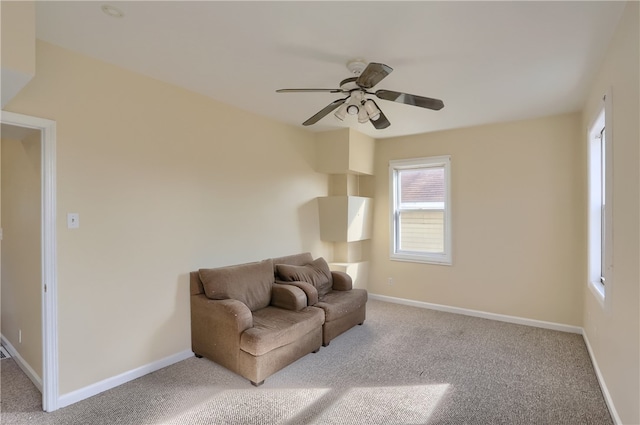 carpeted living room featuring ceiling fan