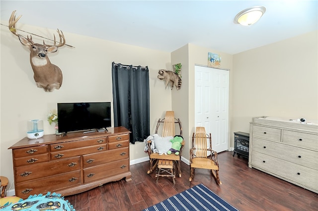 bedroom with a closet and dark hardwood / wood-style floors