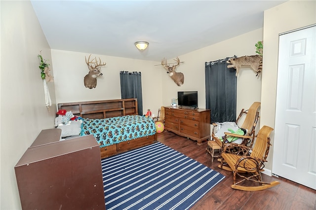 bedroom with dark wood-type flooring