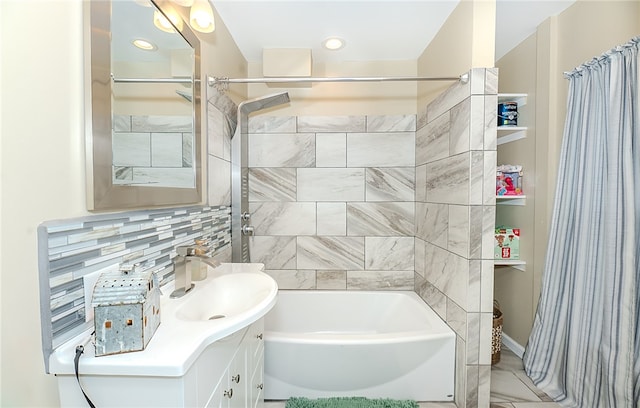 bathroom featuring vanity, shower / bath combo, and tasteful backsplash