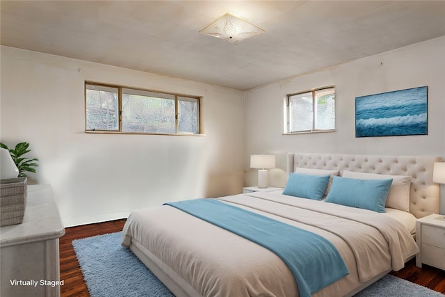 bedroom with dark wood-type flooring