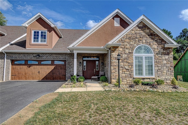 view of front of property featuring a garage and a front lawn