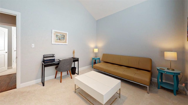 carpeted living room featuring vaulted ceiling