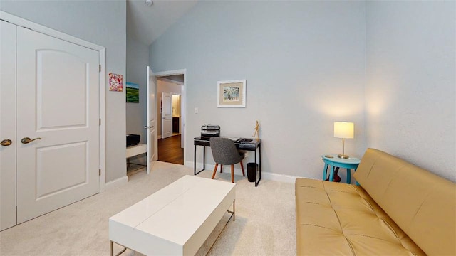 living room with light carpet and high vaulted ceiling