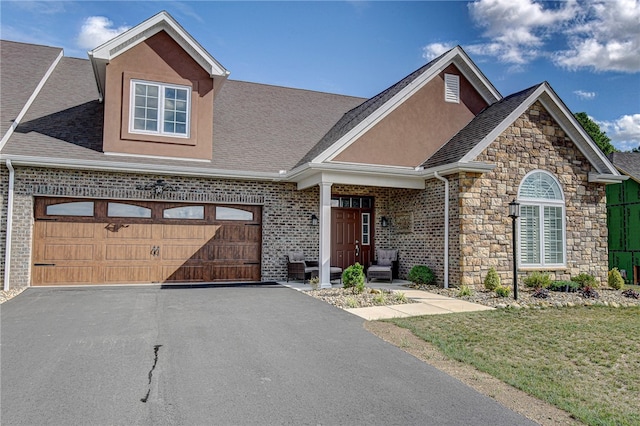 view of front of house featuring a front lawn and a garage