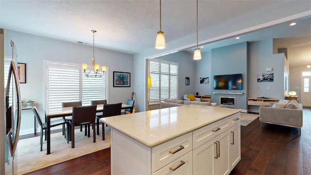 kitchen with an inviting chandelier, decorative light fixtures, white cabinetry, and dark wood-type flooring