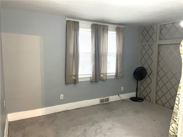 carpeted spare room with a healthy amount of sunlight