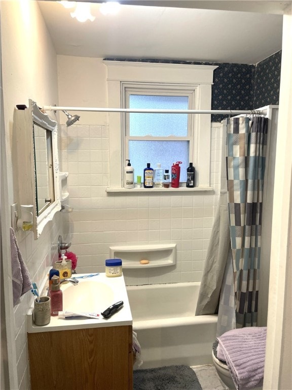 bathroom featuring shower / bath combination with curtain, vanity, and tile walls