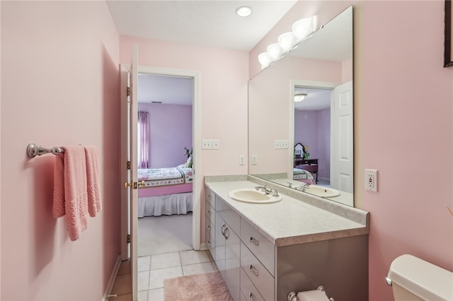 bathroom featuring toilet, vanity, and tile patterned floors