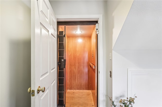 details with wood-type flooring and elevator