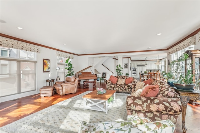 living room featuring wood-type flooring and crown molding