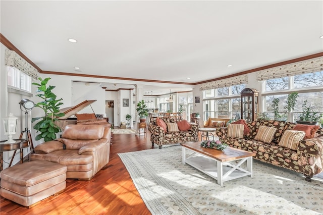 living room with wood-type flooring and ornamental molding