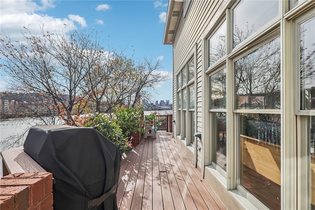 wooden terrace featuring a grill