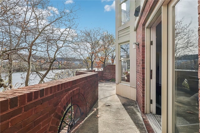 balcony featuring a patio area and a water view