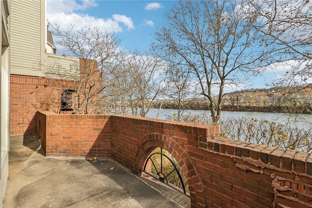 view of patio featuring a water view