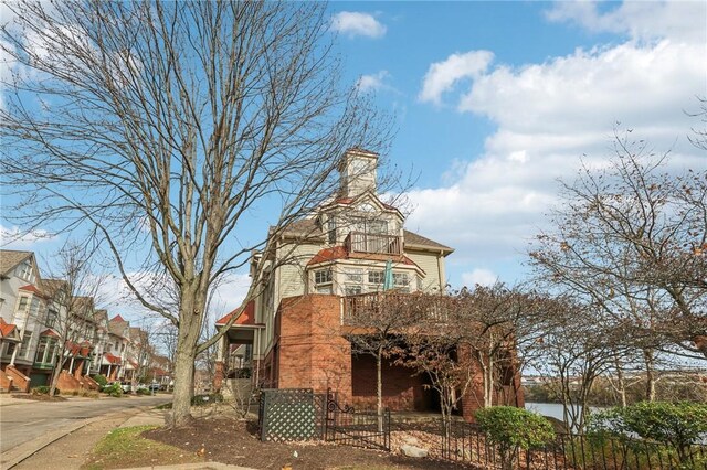 88 Waterfront Dr, Washingtons Landing, PA 15222 - view of front facade featuring fence and a chimney