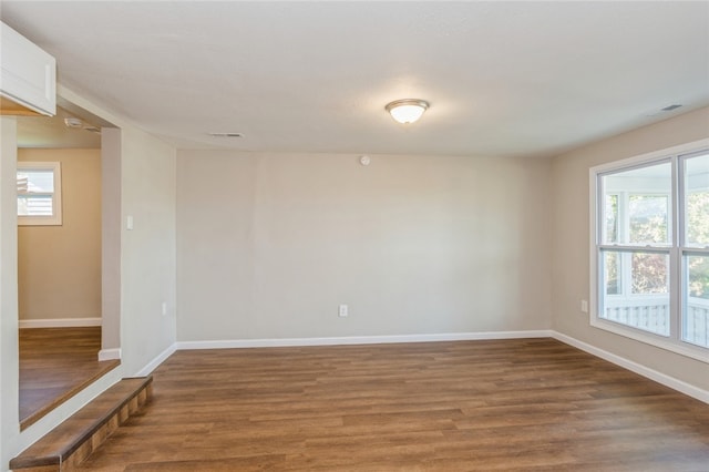 spare room featuring wood-type flooring