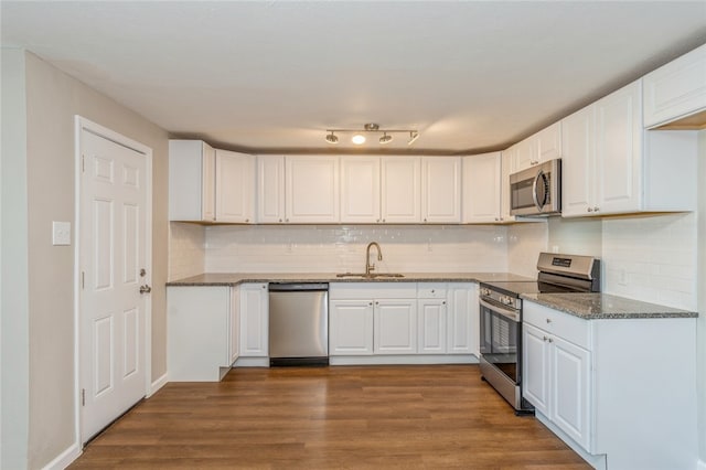 kitchen with white cabinetry, hardwood / wood-style flooring, and appliances with stainless steel finishes