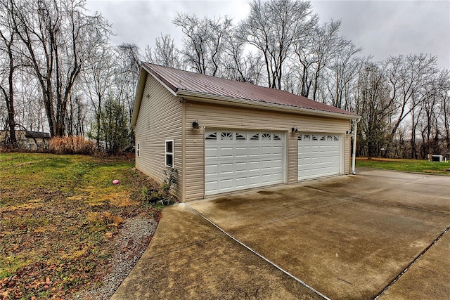 garage featuring a lawn