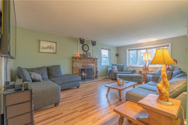 living room featuring a fireplace and light hardwood / wood-style flooring