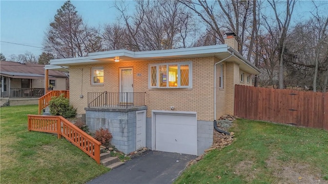 view of front of home with a front yard and a garage