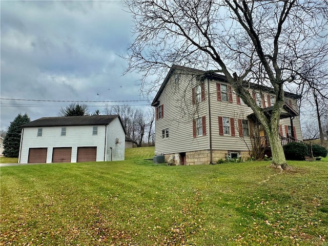 view of property exterior featuring central air condition unit, a yard, an outdoor structure, and a garage