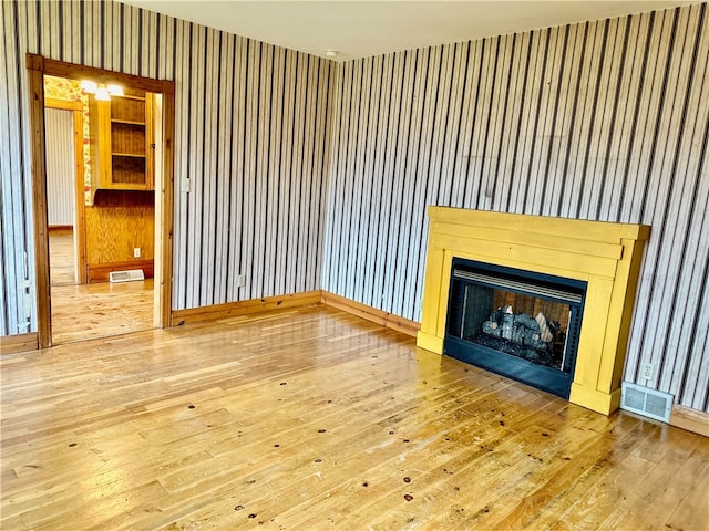 unfurnished living room featuring wood-type flooring